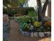 Inviting garden with gravel path, mature trees, and colorful flowers at 13853 W 66Th Pl, Arvada, CO 80004