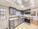Kitchen with stainless appliances, tile backsplash, undermount sink, and shaker cabinets at 13853 W 66Th Pl, Arvada, CO 80004