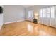 Bright living room with hardwood floors and vaulted ceilings, illuminated by natural light from large windows at 13853 W 66Th Pl, Arvada, CO 80004