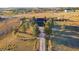 Aerial view of home on a large lot, featuring mature trees, a long driveway and fenced yard at 2312 Arabian Trl, Elizabeth, CO 80107