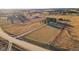 Drone shot of large ranch lot shows home, outbuildings, expansive acreage, and dirt road access at 2312 Arabian Trl, Elizabeth, CO 80107