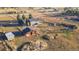 Expansive aerial view of ranch-style home with large lot, barn, outbuildings and mature trees at 2312 Arabian Trl, Elizabeth, CO 80107