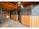 Interior view of the barn featuring several horse stalls and wooden construction at 2312 Arabian Trl, Elizabeth, CO 80107