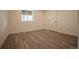 Basement with wood look floors and a window that allows natural light at 2312 Arabian Trl, Elizabeth, CO 80107