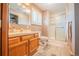 Updated bathroom with walk-in shower, modern vanity, and wood look floors at 2312 Arabian Trl, Elizabeth, CO 80107