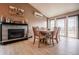Cozy dining area with wood table, fireplace and sliding doors leading to the outdoor at 2312 Arabian Trl, Elizabeth, CO 80107