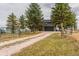 Charming two-story home featuring a spacious driveway, mature trees, and a two-car garage at 2312 Arabian Trl, Elizabeth, CO 80107