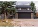 Exterior shot of home with large two car garage and stairs to side entrance of the home at 2312 Arabian Trl, Elizabeth, CO 80107