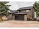 Exterior shot of home with large two car garage and stairs to side entrance of the home at 2312 Arabian Trl, Elizabeth, CO 80107