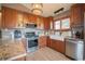 Kitchen with stainless steel appliances, granite countertops and hardwood floors, featuring a farmhouse sink at 2312 Arabian Trl, Elizabeth, CO 80107