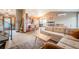 Bright living room showcasing an open concept with hardwood floors, and stairs leading to the upper level at 2312 Arabian Trl, Elizabeth, CO 80107