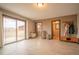 Open-concept living room features sliding glass doors to the backyard and access to the laundry room at 2312 Arabian Trl, Elizabeth, CO 80107