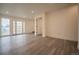 Bright living room featuring modern gray wood flooring and french doors leading to the property's exterior at 2312 Arabian Trl, Elizabeth, CO 80107