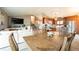 Open layout showcasing the kitchen, living area, dining room, and staircase with wood floors at 2312 Arabian Trl, Elizabeth, CO 80107