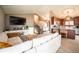 Spacious living room features hardwood floors, comfortable seating, access to kitchen and easy access to the upper level at 2312 Arabian Trl, Elizabeth, CO 80107