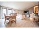 Open-concept living area featuring hardwood floors, large windows, and stylish furnishings at 2312 Arabian Trl, Elizabeth, CO 80107