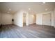 Spacious living room featuring recessed lighting and modern gray wood flooring throughout the area at 2312 Arabian Trl, Elizabeth, CO 80107
