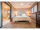Cozy main bedroom featuring carpet floors, neutral walls, an ensuite bathroom and bright windows at 2312 Arabian Trl, Elizabeth, CO 80107