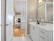 Bright bathroom with modern fixtures, a spacious vanity, and seamless flow to the kitchen at 4625 W 50Th Ave # 203, Denver, CO 80212