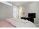 Bright bedroom features modern decor, a TV, and doorways leading to the bathroom and other areas at 4625 W 50Th Ave # 203, Denver, CO 80212