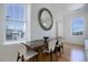 Bright dining room featuring hardwood floors, a rustic wood table, and view-inviting windows at 4625 W 50Th Ave # 203, Denver, CO 80212