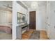 Inviting entryway featuring hardwood floors, a stylish console table, and a view into the bedroom at 4625 W 50Th Ave # 203, Denver, CO 80212