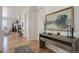 Elegant entryway with wood floors, stylish console table and decorative artwork for a welcoming ambiance at 4625 W 50Th Ave # 203, Denver, CO 80212