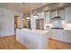 Modern kitchen with stainless steel appliances, white cabinetry, and an island with pendant lighting at 4625 W 50Th Ave # 203, Denver, CO 80212