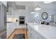 Bright kitchen featuring white cabinets, an island with seating, and stainless steel appliances at 4625 W 50Th Ave # 203, Denver, CO 80212