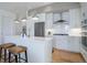 Stylish kitchen featuring a center island with seating, modern appliances, and hardwood floors at 4625 W 50Th Ave # 203, Denver, CO 80212
