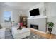 Cozy living room featuring a fireplace, TV, comfortable seating, and natural light at 4625 W 50Th Ave # 203, Denver, CO 80212