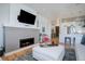 Inviting living room with fireplace, TV, and view to the kitchen offering a modern and comfortable design at 4625 W 50Th Ave # 203, Denver, CO 80212