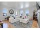 Bright living room features modern decor, hardwood floors, large windows and plush, comfortable seating arrangement at 4625 W 50Th Ave # 203, Denver, CO 80212