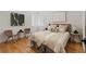 Bright bedroom showcasing hardwood floors, stylish decor, and ample natural light at 2810 N Harrison St, Denver, CO 80205