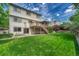 Expansive backyard with well-maintained lawn and a two-story home featuring a large deck, ideal for Gathering activities at 302 Northridge Rd, Highlands Ranch, CO 80126