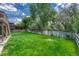 Large backyard with lush green grass, perfect for outdoor activities, surrounded by a wooden fence for privacy at 302 Northridge Rd, Highlands Ranch, CO 80126