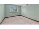 Bedroom with green walls features a bright window and neutral carpet at 302 Northridge Rd, Highlands Ranch, CO 80126