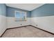 Small bedroom features blue accent wall and neutral carpet at 302 Northridge Rd, Highlands Ranch, CO 80126