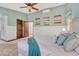 A spacious bedroom features wainscoting, a ceiling fan, and is painted in soothing light green tones at 302 Northridge Rd, Highlands Ranch, CO 80126
