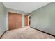 Bedroom with green walls, neutral carpet, closet and entry at 302 Northridge Rd, Highlands Ranch, CO 80126