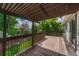 A home's wood deck includes a pergola and overlooks the back yard's mature landscaping at 302 Northridge Rd, Highlands Ranch, CO 80126