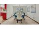 Bright dining room featuring a gray table, carpet, and a window view at 302 Northridge Rd, Highlands Ranch, CO 80126