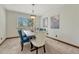 Elegant dining room with stylish chairs, modern lighting, and a bright window at 302 Northridge Rd, Highlands Ranch, CO 80126