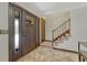 Welcoming entryway featuring tile flooring and a staircase, creating a warm and inviting ambiance at 302 Northridge Rd, Highlands Ranch, CO 80126