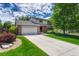 Charming two-story home with a well-manicured lawn and large driveway, perfect for Gathering living at 302 Northridge Rd, Highlands Ranch, CO 80126