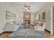 This open-concept living room features a brick fireplace and hardwood floors at 302 Northridge Rd, Highlands Ranch, CO 80126