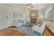 Cozy living room featuring hardwood floors, a fireplace, and lots of natural light at 302 Northridge Rd, Highlands Ranch, CO 80126