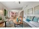 Bright living room with hardwood floors and open concept layout leading into the kitchen at 302 Northridge Rd, Highlands Ranch, CO 80126