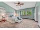 Large bedroom features bright windows, neutral carpet and light blue accent wall at 302 Northridge Rd, Highlands Ranch, CO 80126