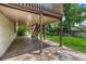 Covered patio area with stamped concrete, providing a shaded outdoor space for relaxation and entertainment at 302 Northridge Rd, Highlands Ranch, CO 80126